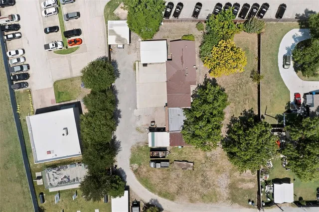 an aerial view of a house with swimming pool and garden