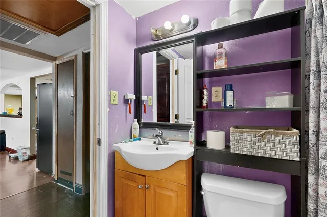 a kitchen with stainless steel appliances granite countertop a sink dishwasher stove and cabinets with wooden floor