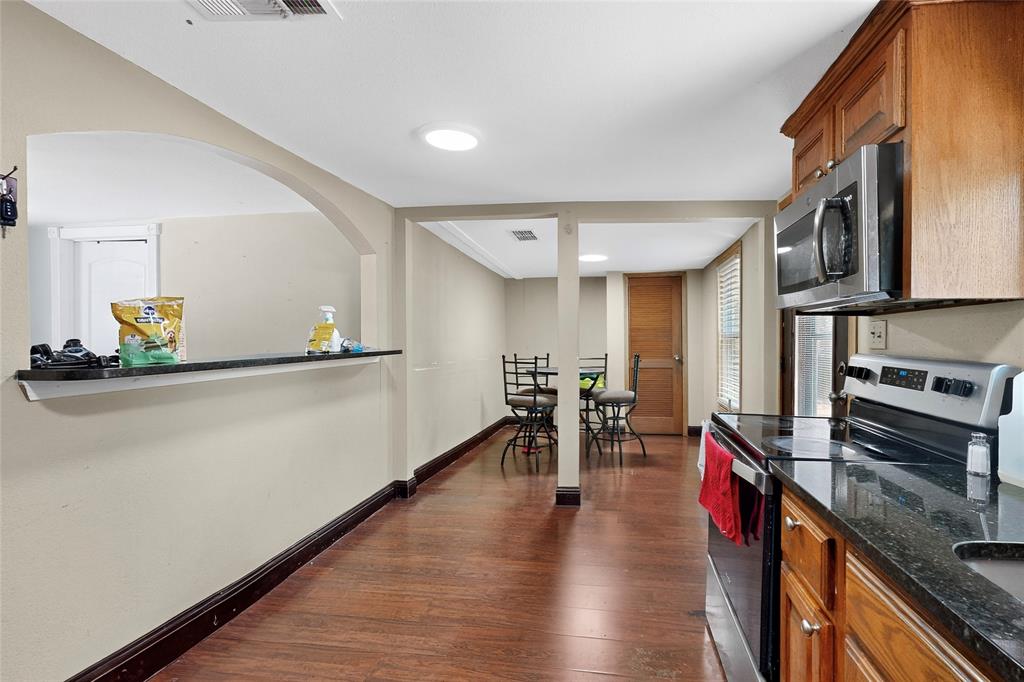 940 Rowlett Road Rowlett, TX 75088 - Photo 21 of 37 a kitchen with stainless steel appliances granite countertop a stove and a refrigerator