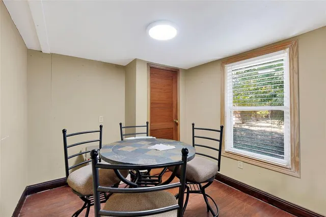 a kitchen with granite countertop a refrigerator stove top oven and sink