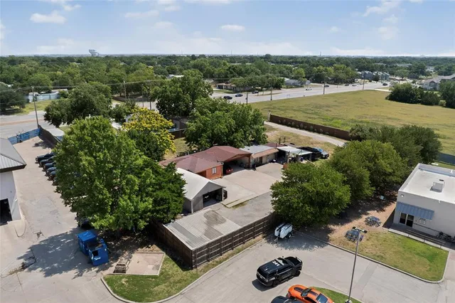 an aerial view of a house with garden space and street view