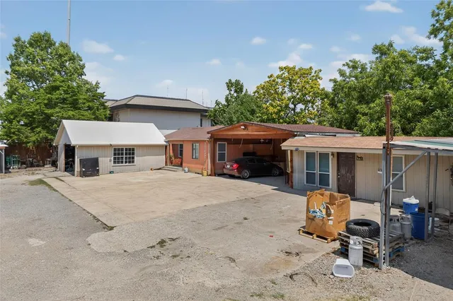 a view of a house with a patio and a yard