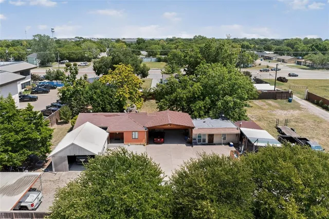 an aerial view of a house with a yard and lake view