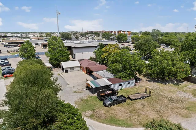 an aerial view of a house with a yard garage lake and outdoor seating