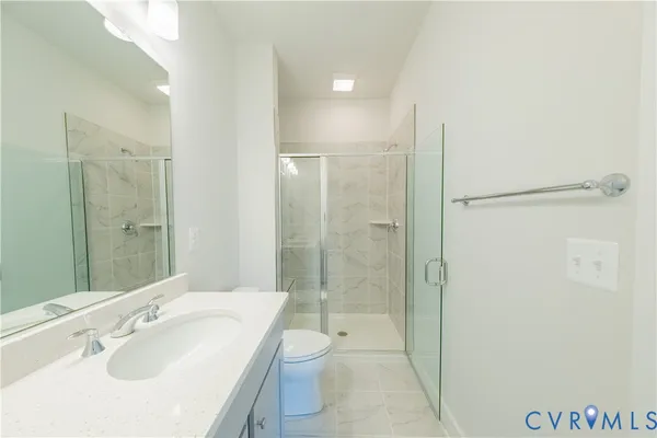 a kitchen with kitchen island wooden floors appliances and cabinets