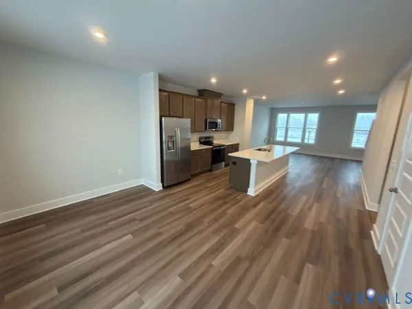 a kitchen with wooden floors and wooden cabinets