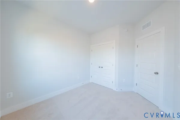 a view of an empty room and a window