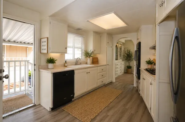 a kitchen with a refrigerator a sink and cabinets