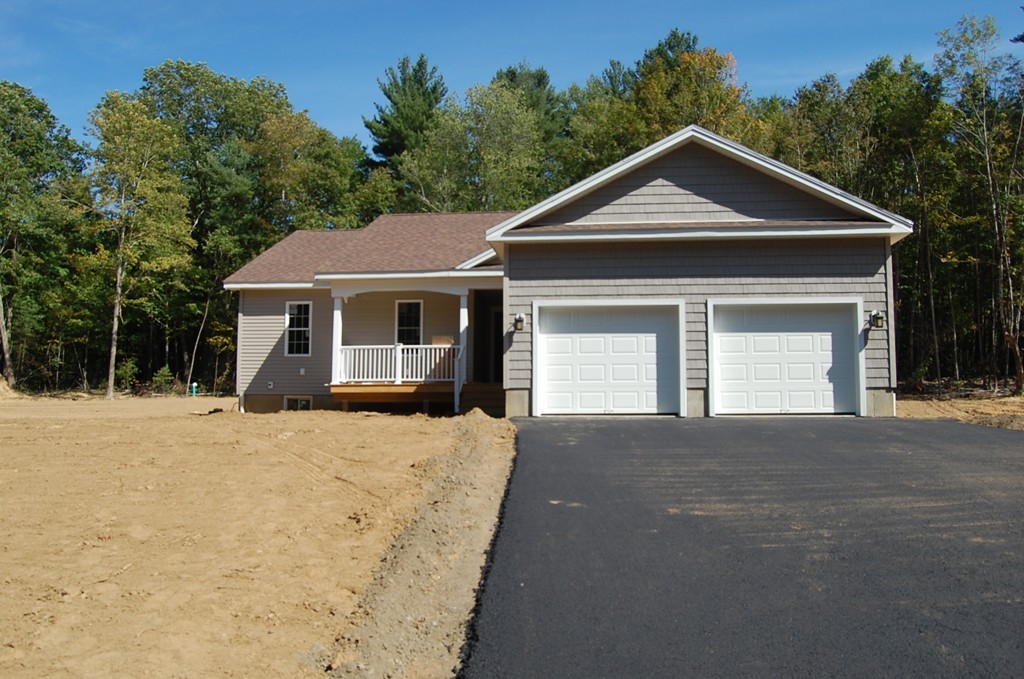 575 Podunk Road East Brookfield, MA 01515 - Photo 1 of 8 a front view of a house with a yard and garage