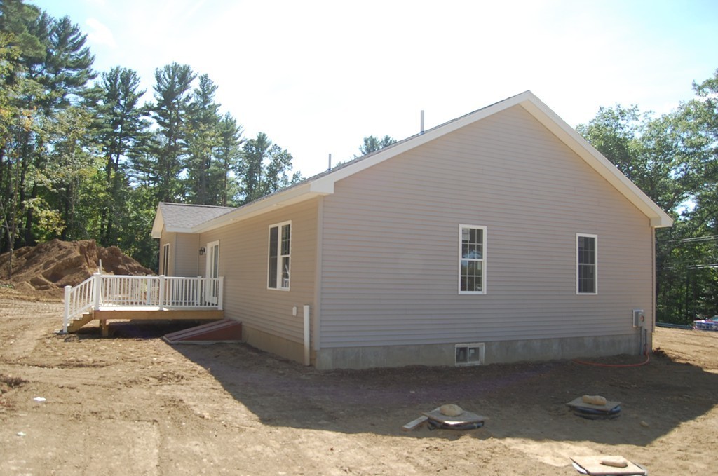 575 Podunk Road East Brookfield, MA 01515 - Photo 2 of 8 a backyard of a house with barbeque oven and brick wall