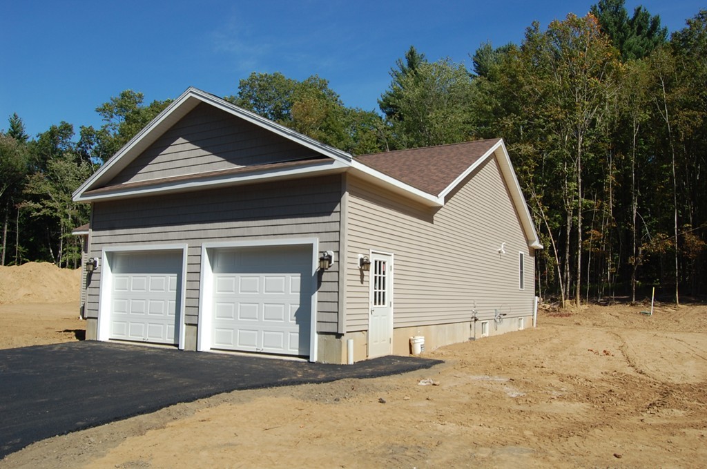 575 Podunk Road East Brookfield, MA 01515 - Photo 4 of 8 a front view of a house with a yard and garage
