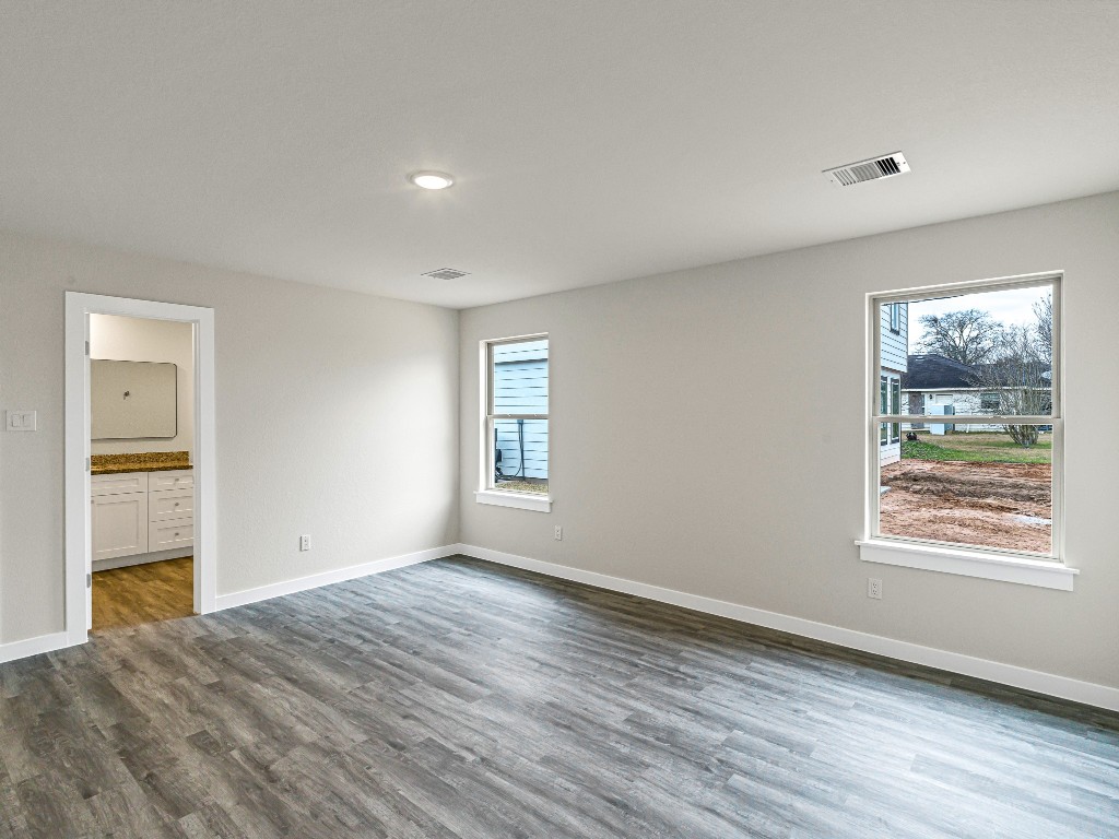 1010 4th Street Hempstead, TX 77445 - Photo 14 of 23 a view of an empty room with wooden floor and a window