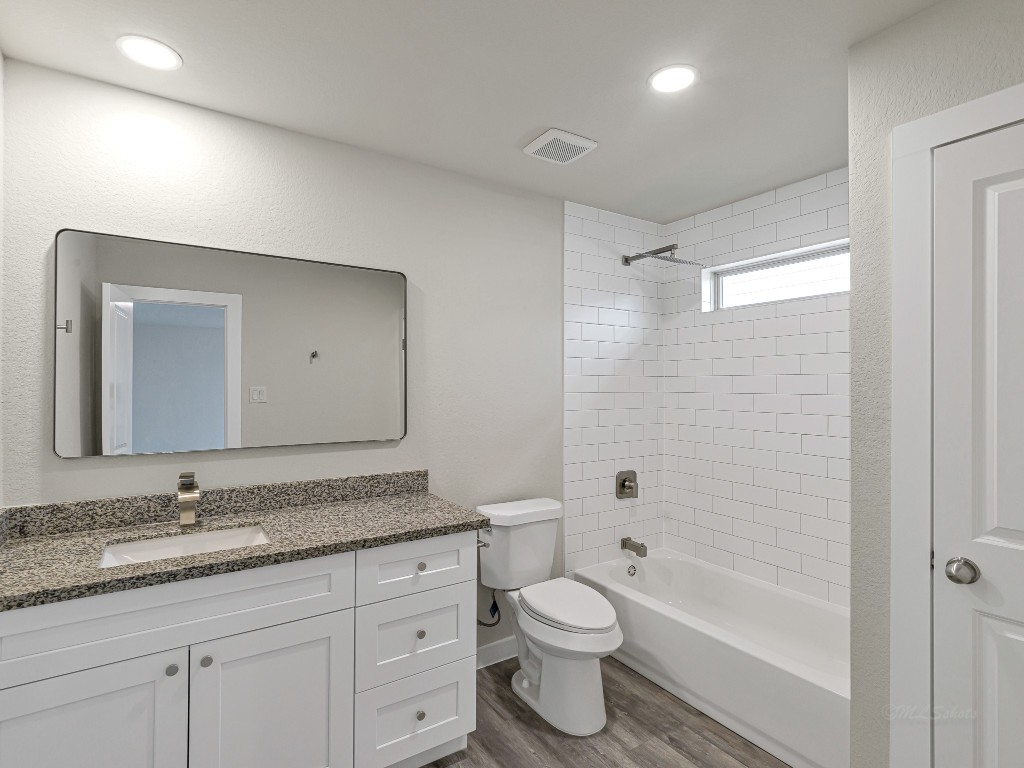 1010 4th Street Hempstead, TX 77445 - Photo 15 of 23 a bathroom with a granite countertop sink toilet and shower