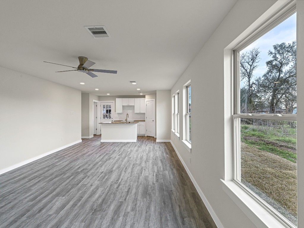 1010 4th Street Hempstead, TX 77445 - Photo 5 of 23 a view of a kitchen with wooden floor a sink and a window