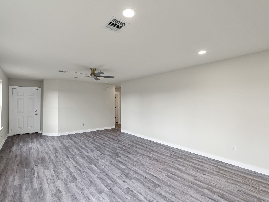 1010 4th Street Hempstead, TX 77445 - Photo 8 of 23 an empty room with wooden floor and windows