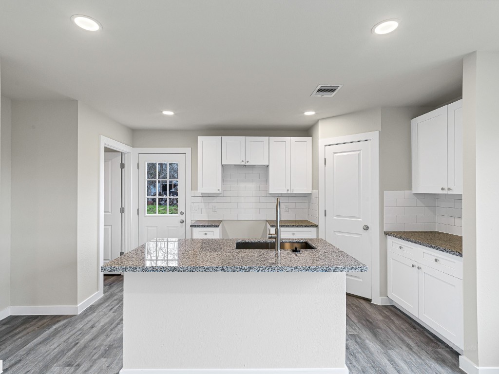 1010 4th Street Hempstead, TX 77445 - Photo 9 of 23 a kitchen with stainless steel appliances granite countertop a sink stove and cabinets