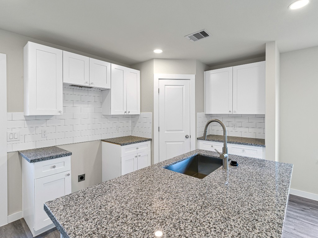 1010 4th Street Hempstead, TX 77445 - Photo 10 of 23 a kitchen with a sink stove and cabinets