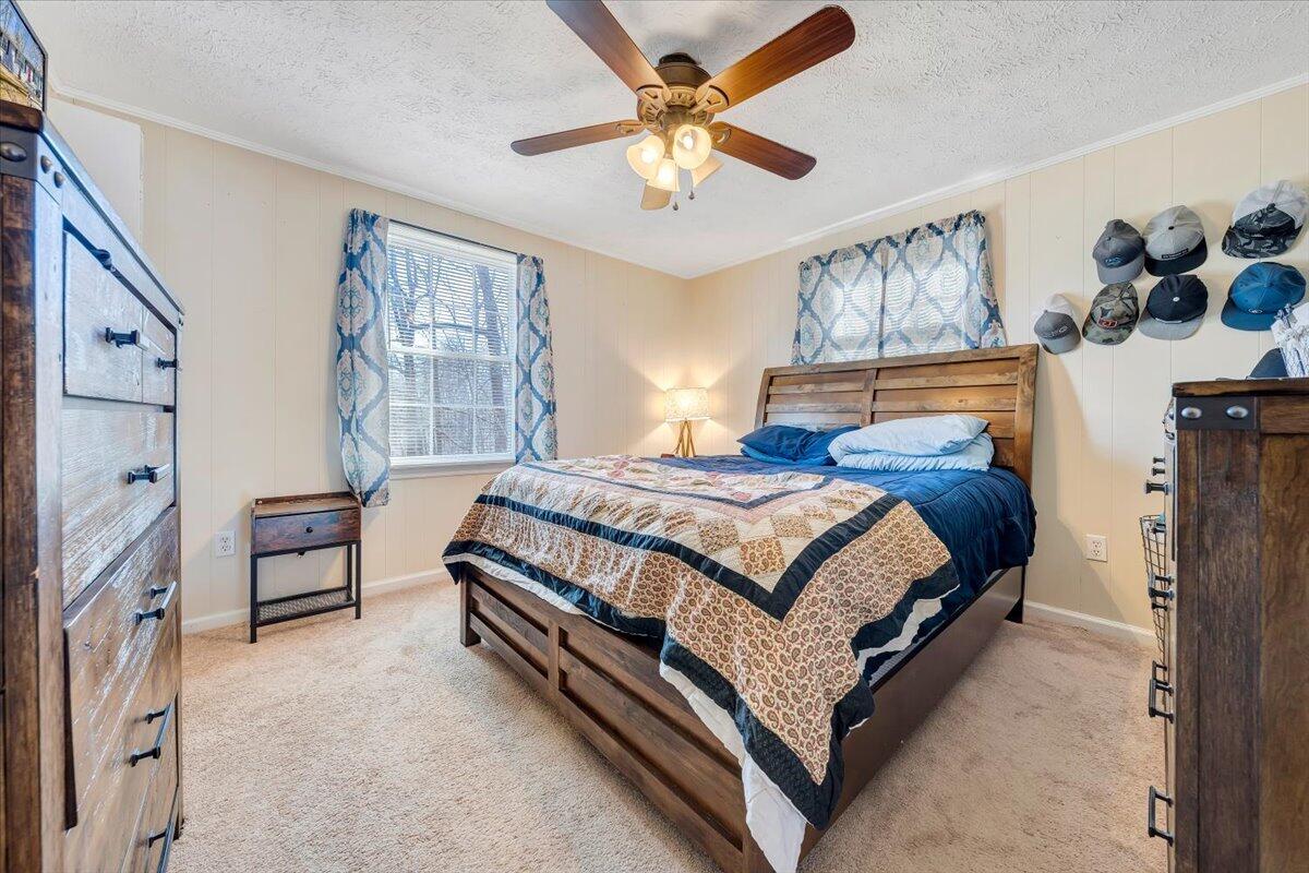 1173 Sawmill Road Ferrum, VA 24088 - Photo 14 of 39 a bedroom with a bed and a chandelier