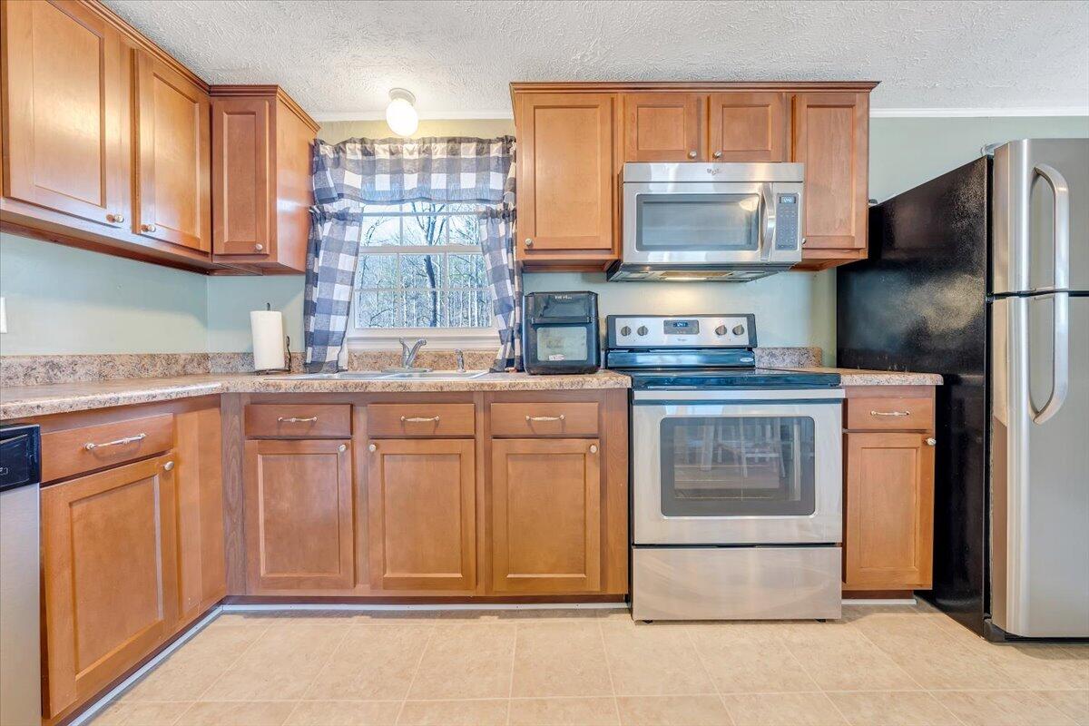 1173 Sawmill Road Ferrum, VA 24088 - Photo 7 of 39 a kitchen with stainless steel appliances granite countertop a refrigerator sink and cabinets
