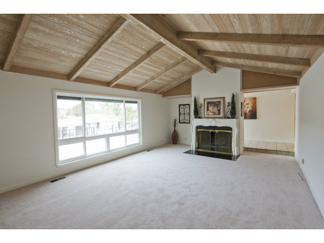 10146 Alpine Drive Cupertino, CA 95014 - Photo 4 of 15 a view of an empty room with a fireplace and a window