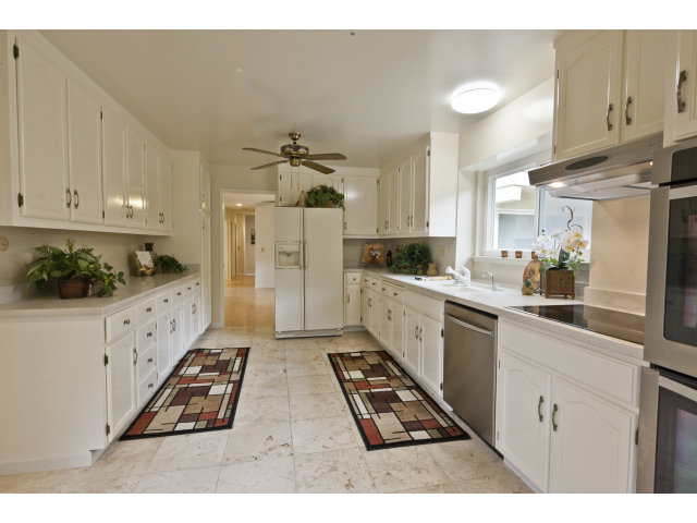 10146 Alpine Drive Cupertino, CA 95014 - Photo 6 of 15 a kitchen with stainless steel appliances kitchen island granite countertop a refrigerator a sink dishwasher and white cabinets with wooden floor
