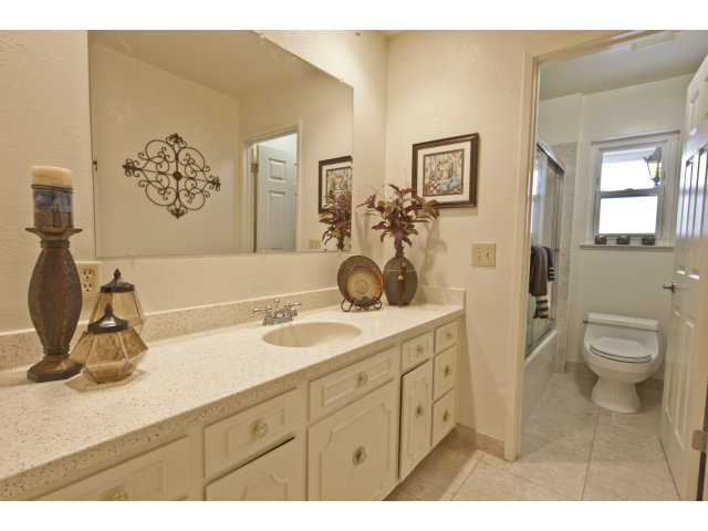 10146 Alpine Drive Cupertino, CA 95014 - Photo 9 of 15 a spacious bathroom with a granite countertop sink mirror and painting on the wall