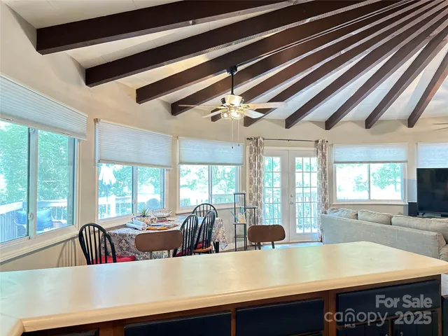 a view of a room with kitchen island a sink and a large window