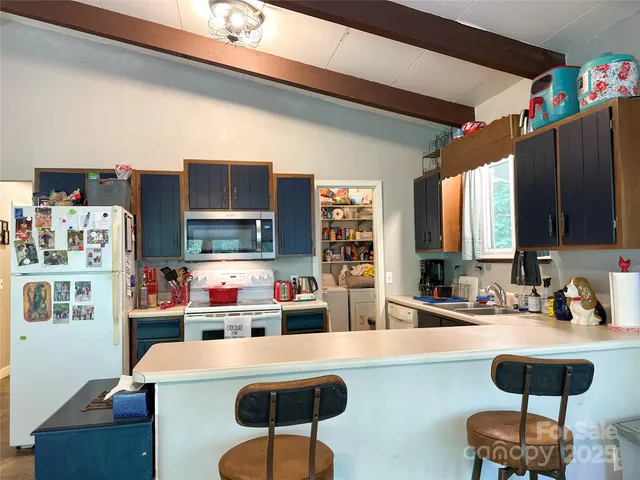 a kitchen with a dining table and chairs