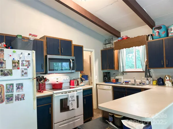 a kitchen that has a sink and a stove in it