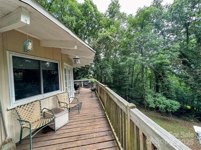 a balcony with wooden floor and outdoor space