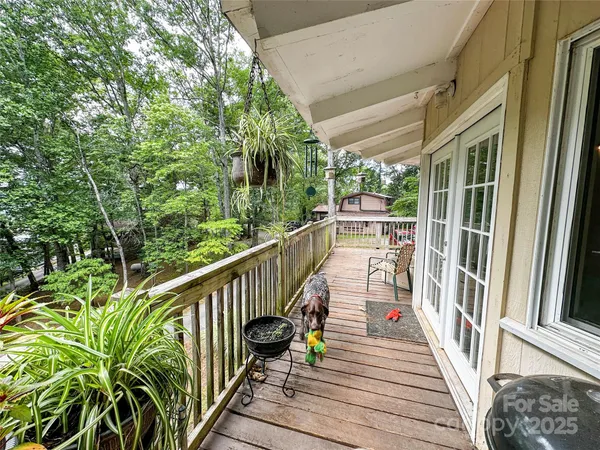 a view of balcony with wooden floor and fence