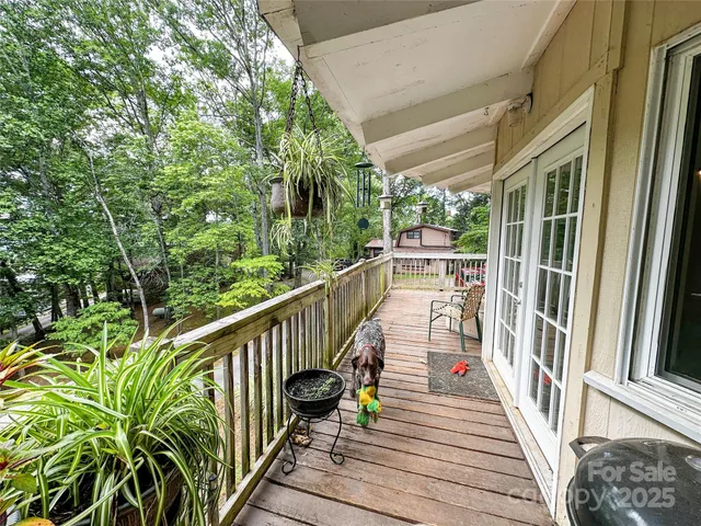 a view of balcony with wooden floor and fence