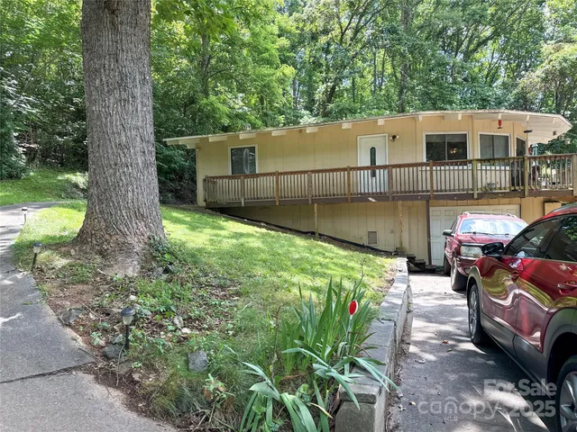 an outdoor view of a house with a fence