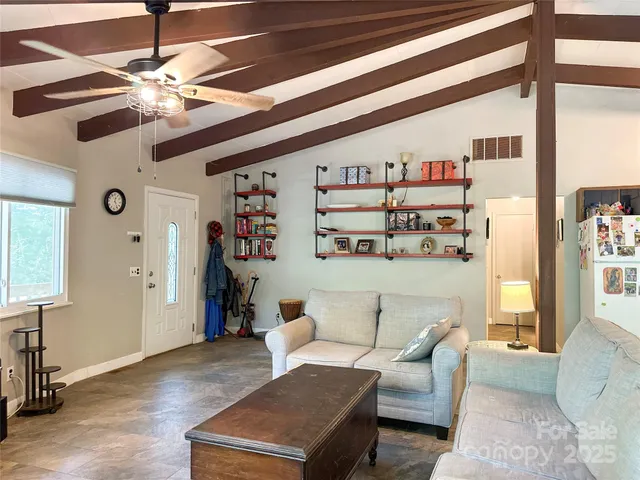 a living room with furniture and chandelier