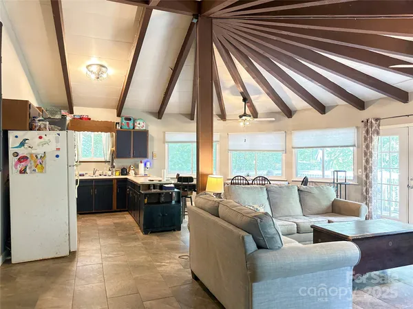 a living room with furniture and large windows