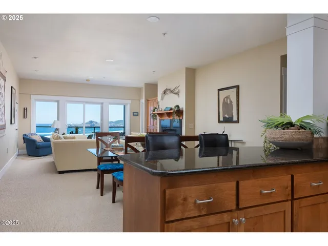 a kitchen with granite countertop a refrigerator stove top oven and sink