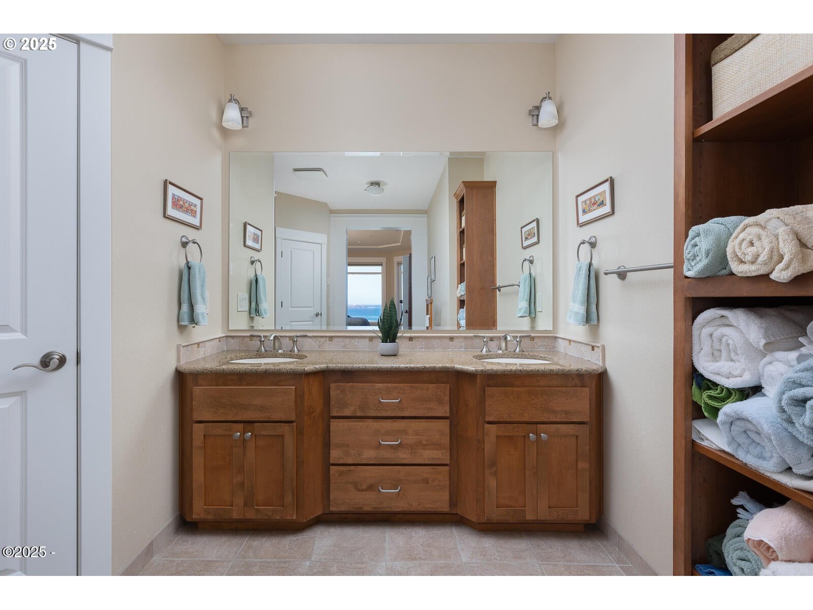 1125 Northwest Spring Street, Unit A302 Newport, OR 97365 - Photo 19 of 31 a bathroom with a granite countertop sink and a mirror