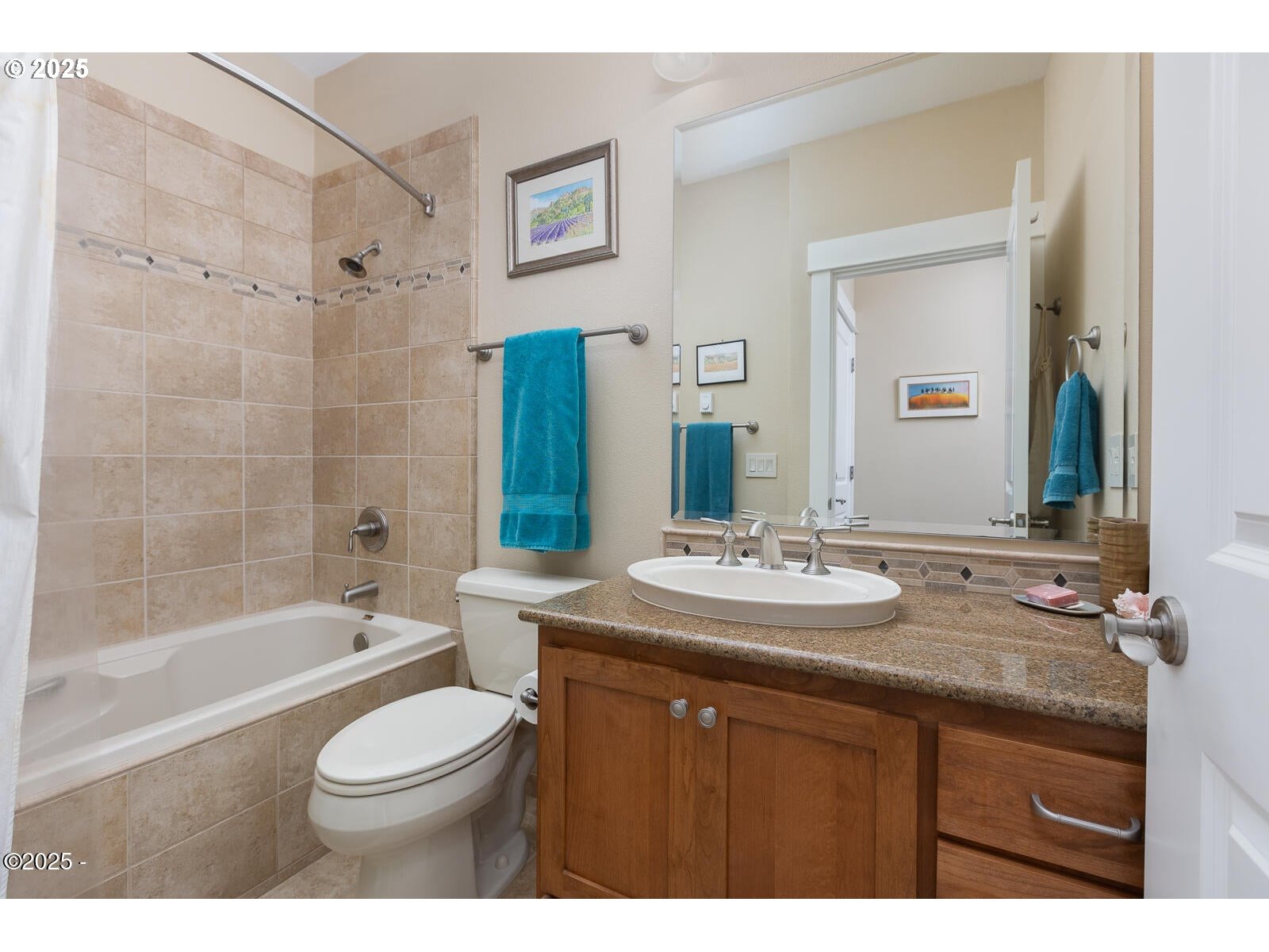 1125 Northwest Spring Street, Unit A302 Newport, OR 97365 - Photo 23 of 31 a bathroom with a granite countertop sink toilet a mirror a bathtub and shower