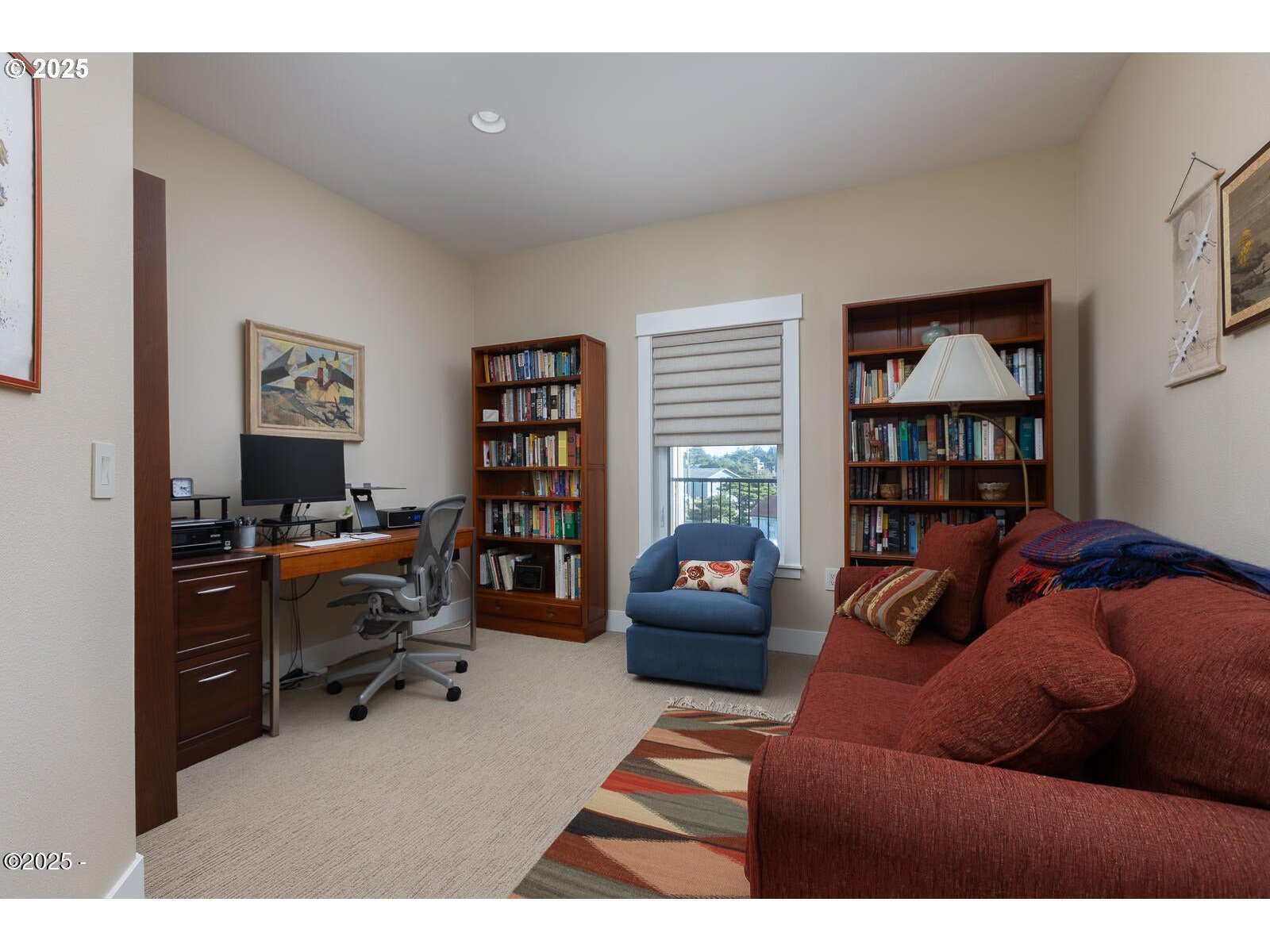 1125 Northwest Spring Street, Unit A302 Newport, OR 97365 - Photo 24 of 31 a living room with furniture and a bookshelf
