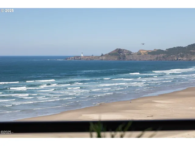 a living room with furniture a fireplace and a large window