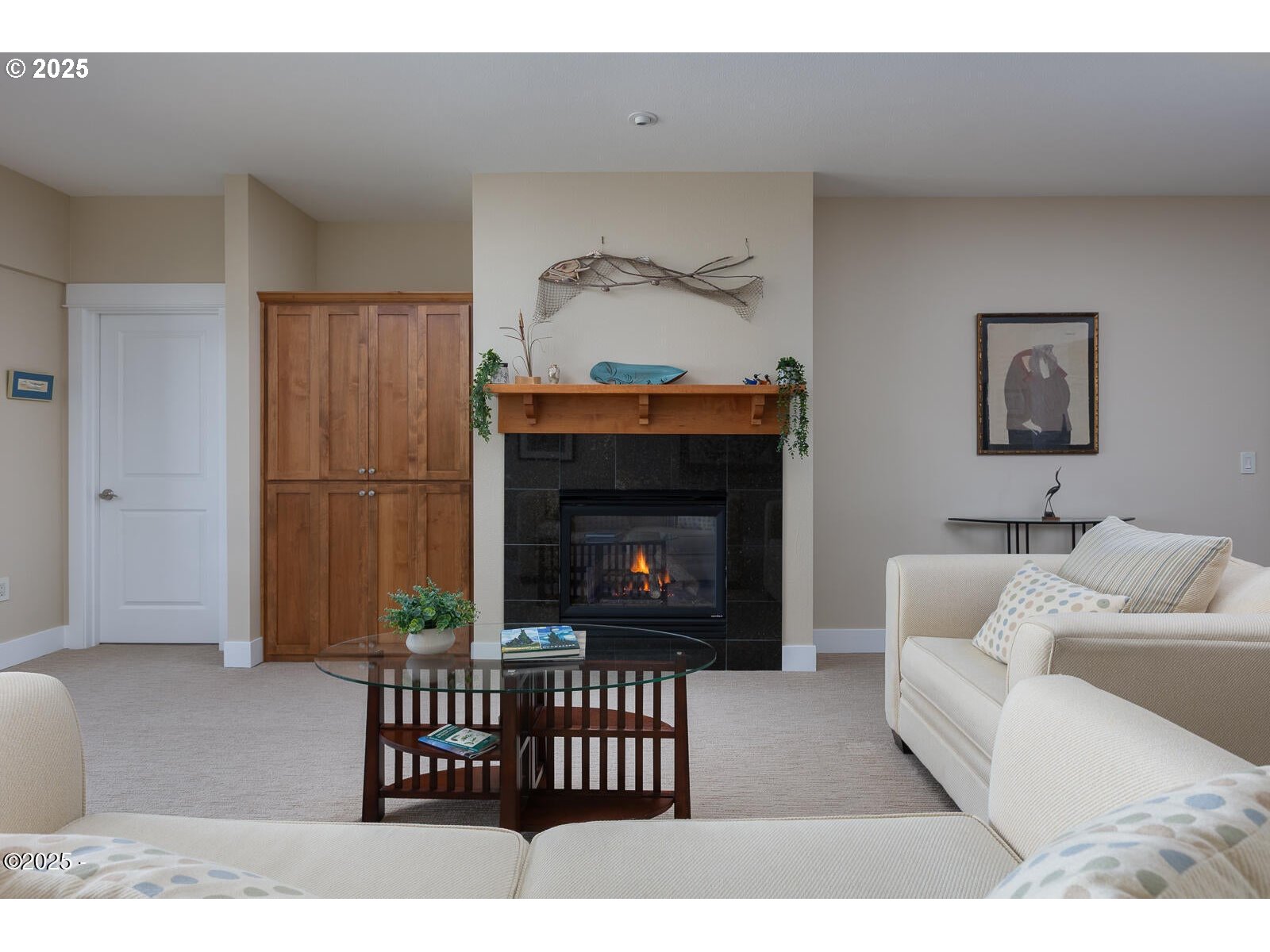 1125 Northwest Spring Street, Unit A302 Newport, OR 97365 - Photo 9 of 31 a living room with furniture a fireplace and a flat screen tv