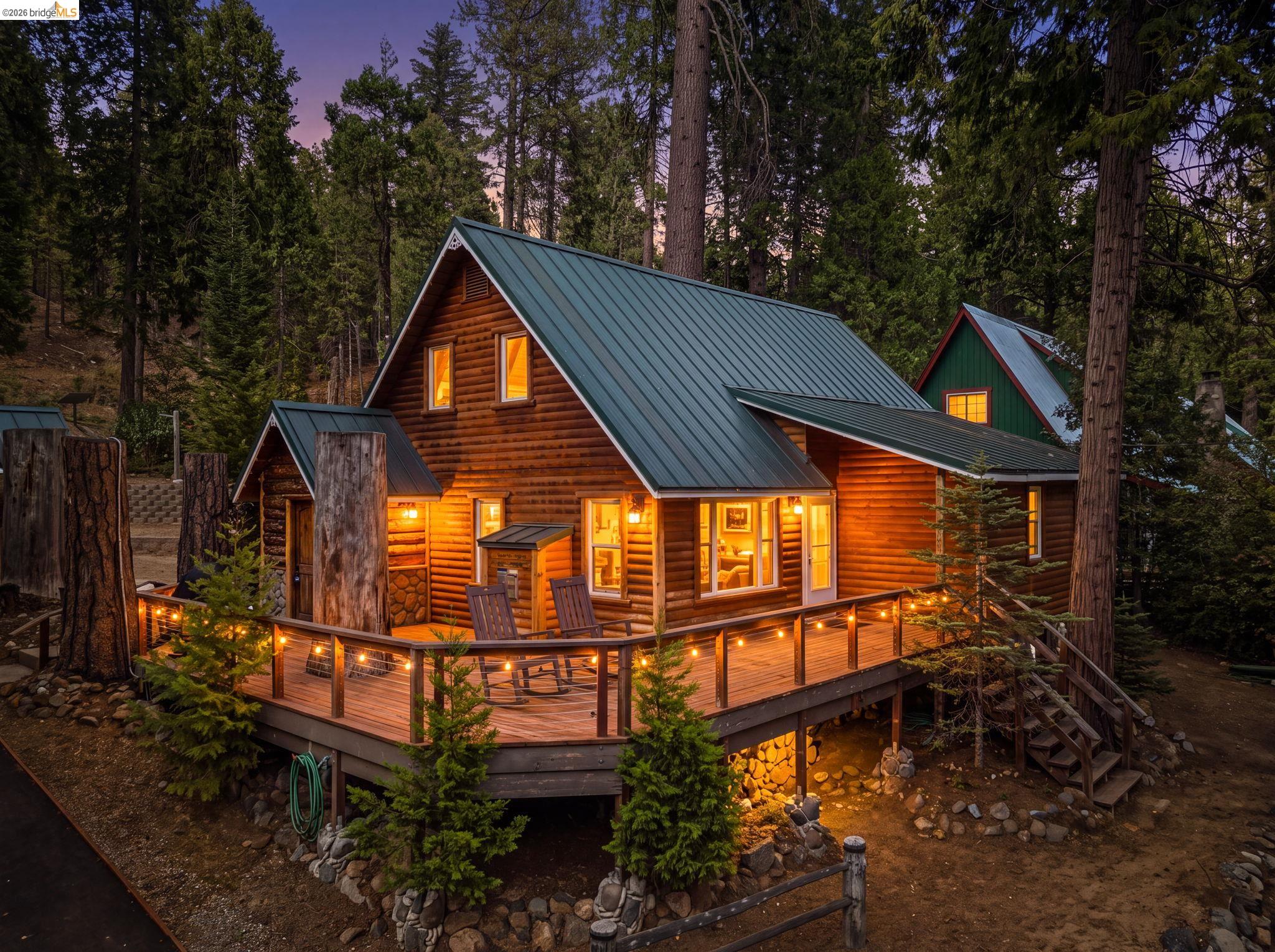 25972 Long Barn Road Long Barn, CA 95335 - Photo 1 of 36 Swiss Family Robinson inspired cabin in the woods! Wood-sided with natural stone and featuring a metal roof.
