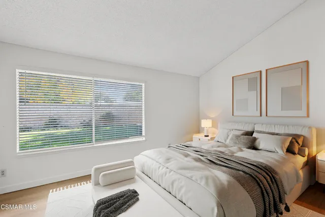 a bedroom with a bed and glass windows