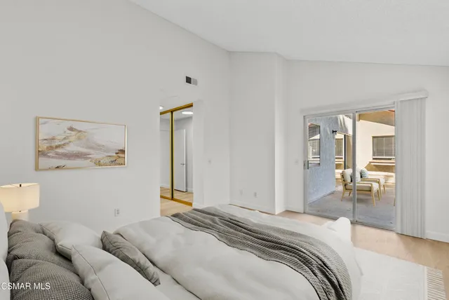 a spacious bathroom with a granite countertop tub sink and mirror