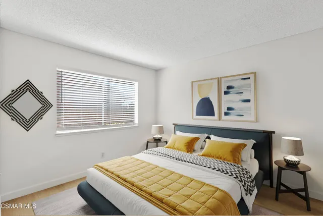 a bedroom with a bed and window