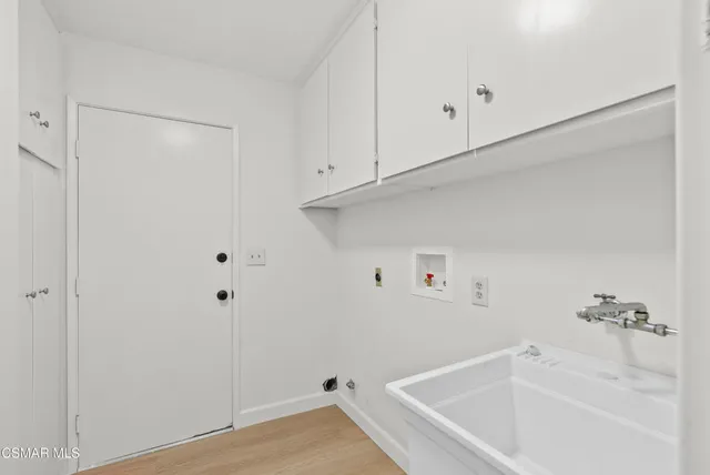 a view of a patio with couches and a potted plant on a table