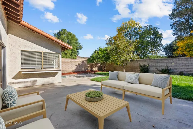 a front view of a house with a garden and yard