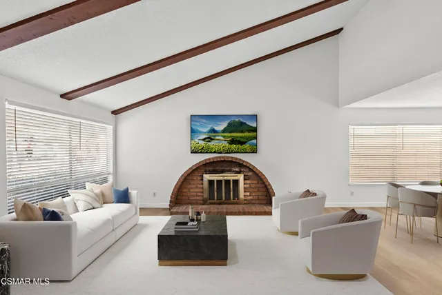 a living room with furniture a couch and a window with outer view