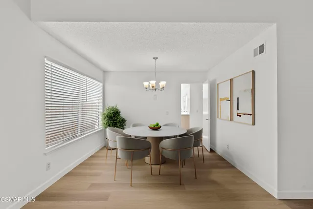 a view of a dining room with furniture and window