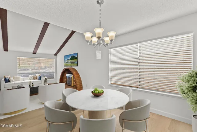 a view of a dining room with furniture and chandelier